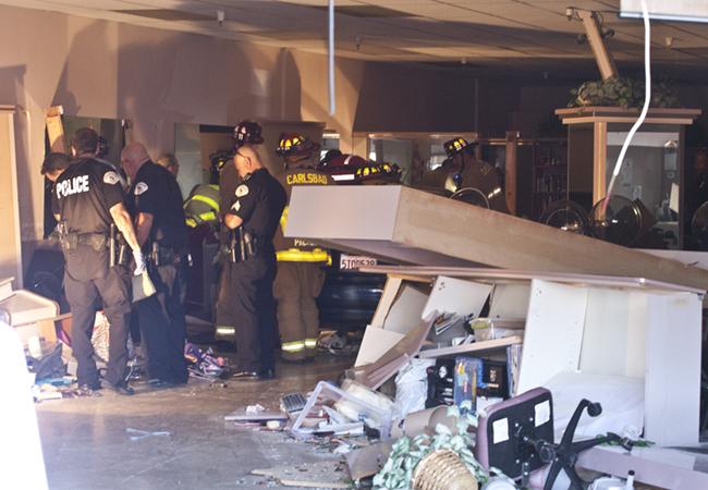 Firefighters+work+to+extricate+a+woman+pinned+by+a+BMW+that+was+driven+into+the+Country+Club+Salon%2C+in+Oceanside+Photo%3A+Steve+Marcotte%2FOsideNews