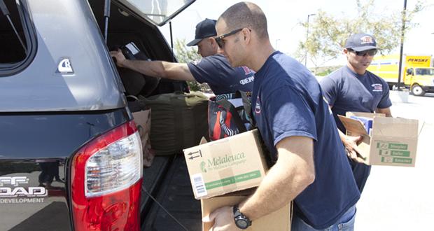 Oceanside Firefighters Marshal Minogue, Kyle Kruthaup and James Thompson unload donated items during Donate-First Day