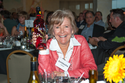 After winning the bid on the last available bottle of award-winning Wild Thing wine, Barbara Harper laughs as she acknowledges, “I don’t even drink Rosé!” (courtesy photo)
