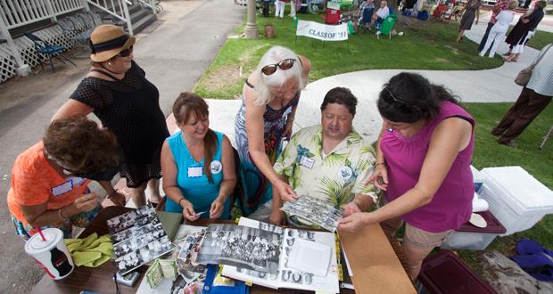 Holiday Geiger, Mona Greenspan, Linda Warren-Graph, Linda Satterly and Earl Warren look through old yearbooks at the 2015 reunion (file photo)