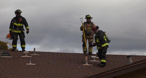 Firefighters use thermal imaging to detect hot spots in the attic