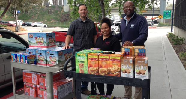 A donation to the City College Food Pantry from City College alum and Columbia University grad, Friend of Downtown member, Michael Taylor. He came with a colleague and donated two carts of food from his San Diego business called NWB Environmental Services, LLC. The student in the image (young woman) is Small Business Entrepreneurship Program intern Lisa. (courtesy photo)