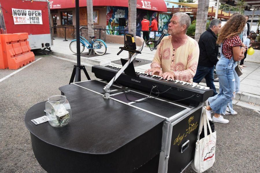 Ted White, the Song Peddler, performs for Encinitas Spring Street Fair attendees on Sunday morning, April 10. (Photo by Charlene Pulsonetti)