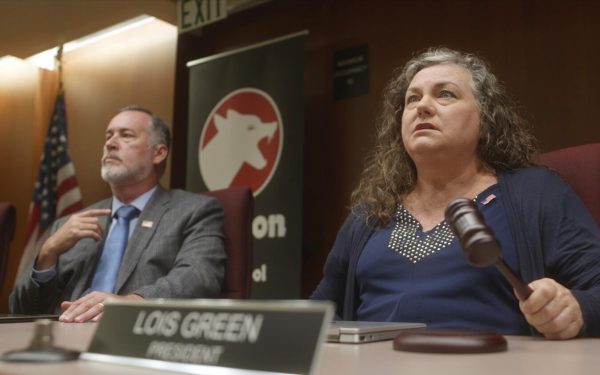 Denice Riddle (right) stars as disgruntled school board president Lois Green in the short film “Red Blooded,” which has been nominated for five 2024 San Diego Film Awards. Encinitas actor Mark Allyn (left) plays school board member Michael Lancet. (Mercury Cinema photo)