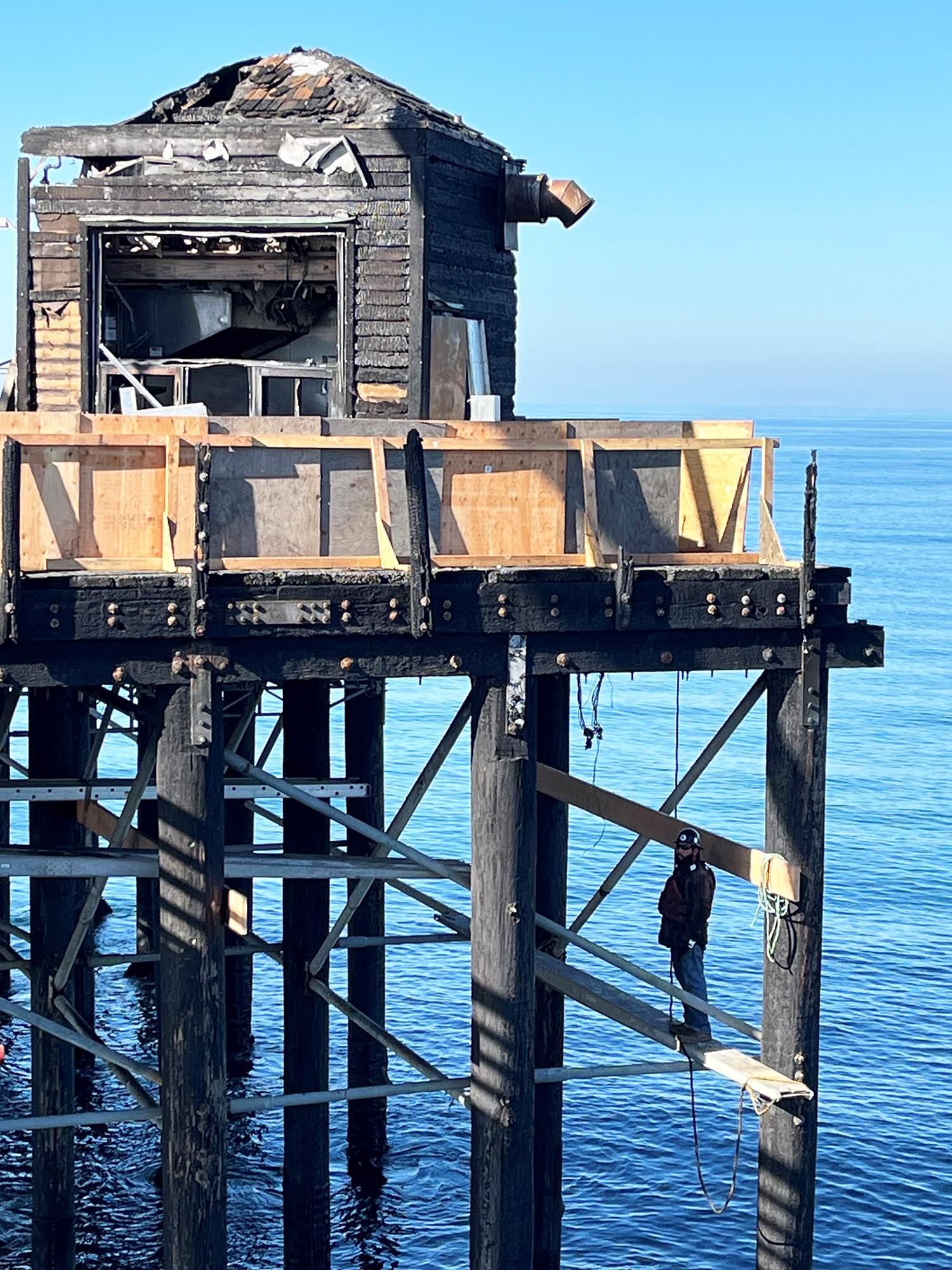 Demolition crews began removing burned structures from the end of Oceanside Pier on Wednesday, Oct. 23, as part of an ongoing effort to rehabilitate the structure after a blaze last spring.