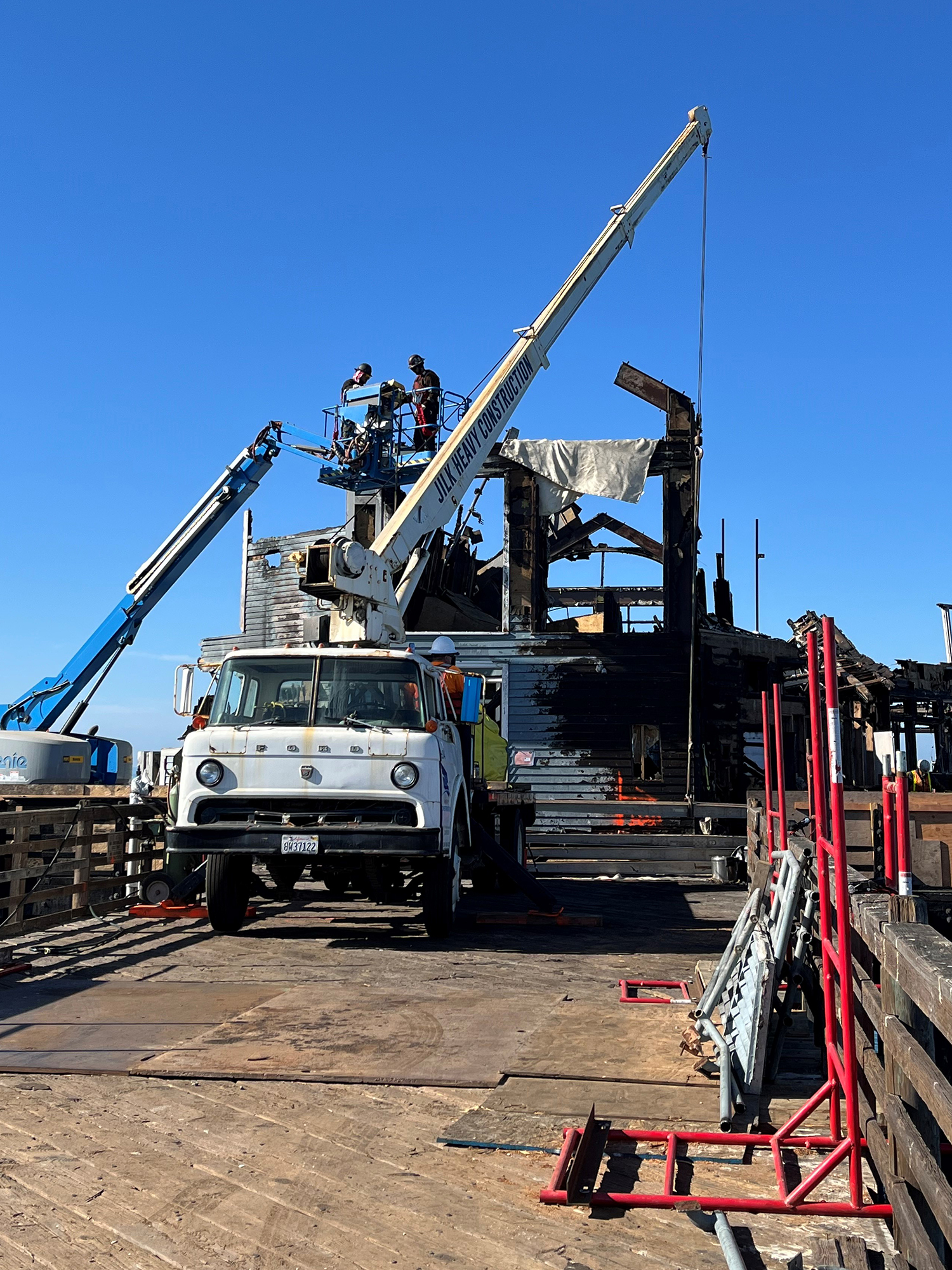 Demolition crews began removing burned structures from the end of Oceanside Pier on Wednesday, Oct. 23, as part of an ongoing effort to rehabilitate the structure after a blaze last spring.